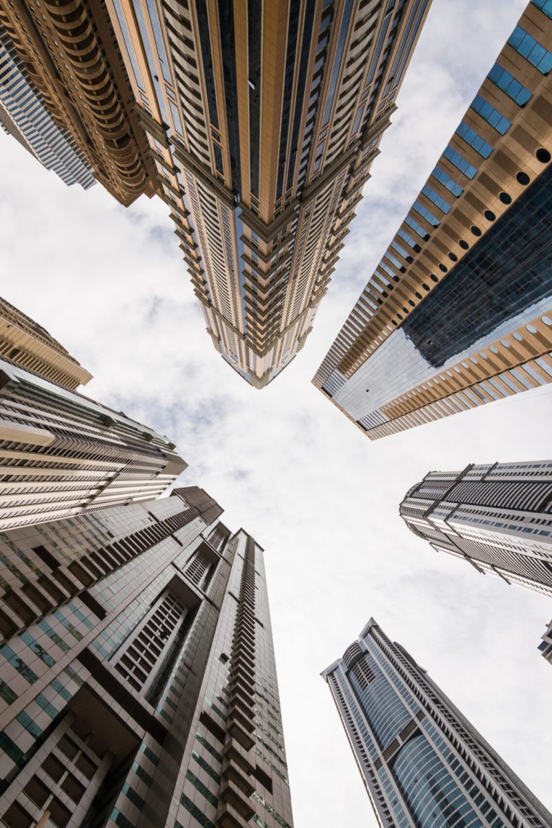 Dramatic perspective with low angle view of skyscrapers looking up to the sky, Dubai. Dramatic perspective with low angle view of skyscrapers looking up to the sky, Dubai. Vanishing point